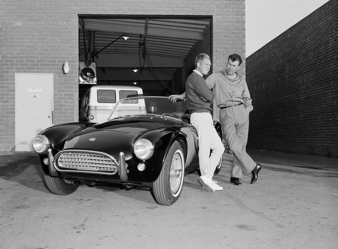 Actor Steve McQueen, left, and racer Carroll Shelby stand by McQueen's Ford-Cobra roadster, June 28, 1963, in Los Angeles.