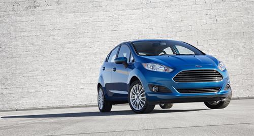 2014 Ford Fiesta 5dr: The 2014 Fiesta sports the stylish new face of Ford with a new grille, hood and tapered lines for a fun-to-drive look that makes customers want to get in and go. 