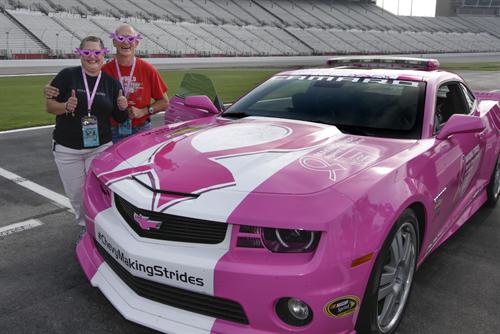 Cancer survivors Sam and Tracie Shields of Smyrna, Georgia stand next to a specially themed pink Chevrolet Camaro SS that will serve as the pace car for the NASCAR Sprint Cup Series Advocare 500 race Sunday.
